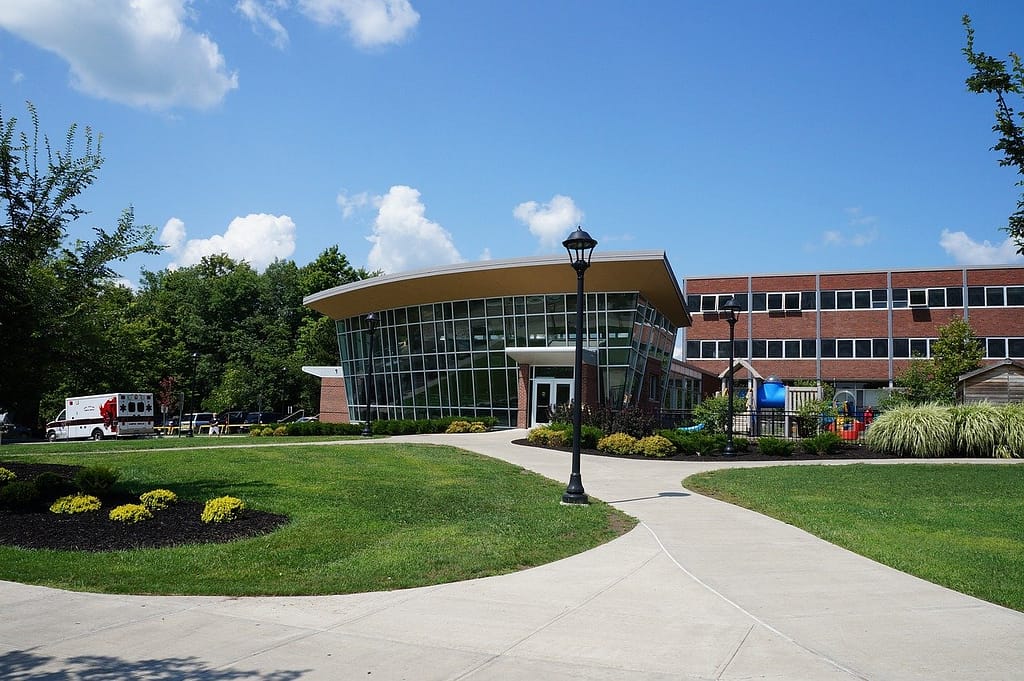 Front view of a university building with modern architecture and green landscaping, resembling the University of South Florida.